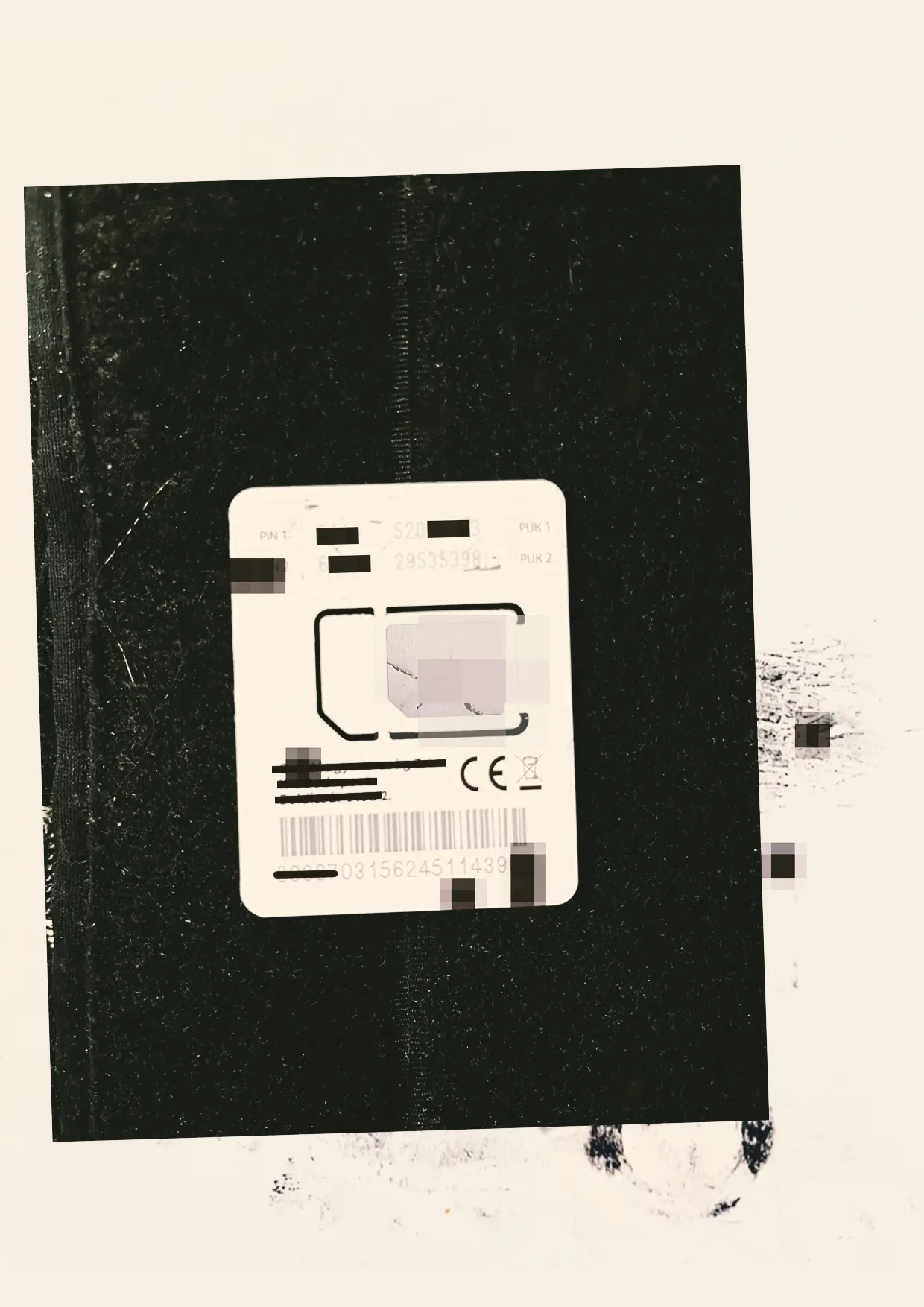 A worn black surface and SIM card.
